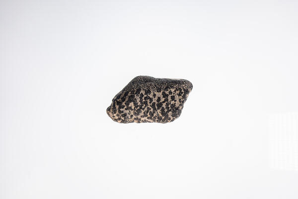 High-definition image of chromite specimen with visible crystal grains and dark coloration.