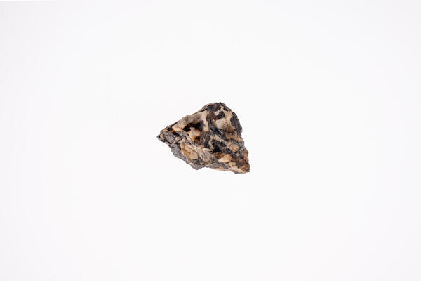 High-definition image of a second columbite-tantalite specimen, showing its dark coloration, rough surface.