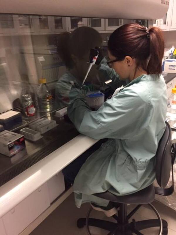 Woman in lab pipetting