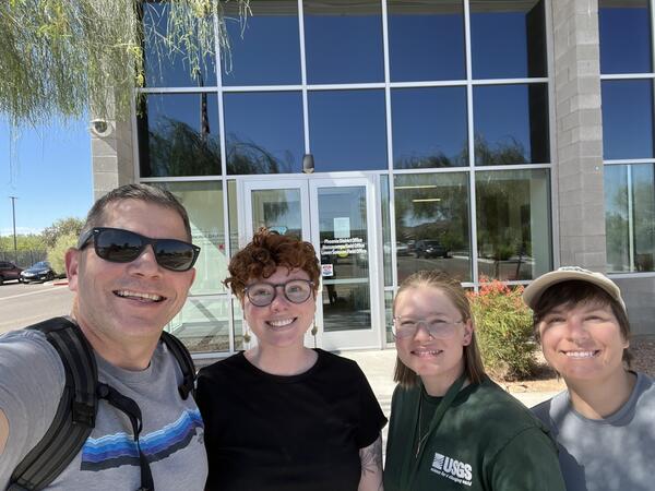 Four people smile in front of a Bureau of Land Management office in Phoenix, Arizona