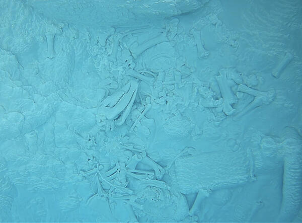 underwater image of bones lying at the bottom of a blue-water hot spring