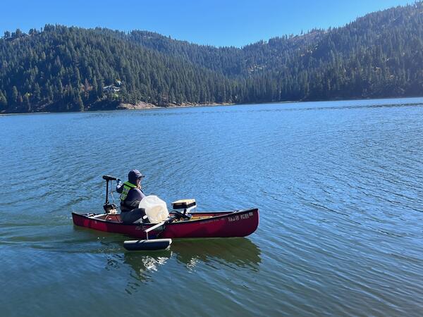 USGS hydrologist on Fernan Lake in a canoe sampling the water