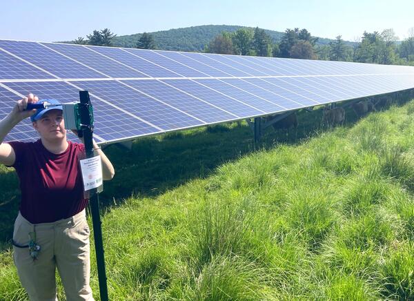 Graduate student at a solar energy field in the Northeast U.S.