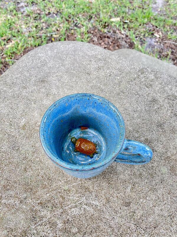 blue pottery mug with orange pond turtle