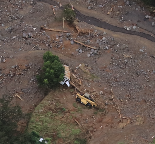 Fully destroyed trailer/home being excavated from mud