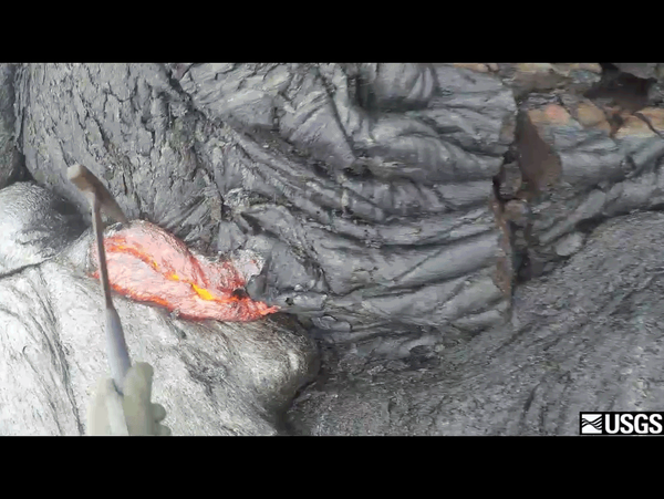 A repeating loop showing a hammer scooping lava from a flow and dropping it into a bucket.