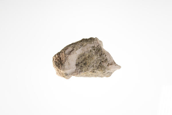 High-definition image of magnesite specimen with earthy texture and white-gray tones.