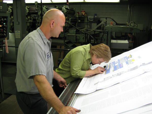 Linda Masonic inspecting map before printing