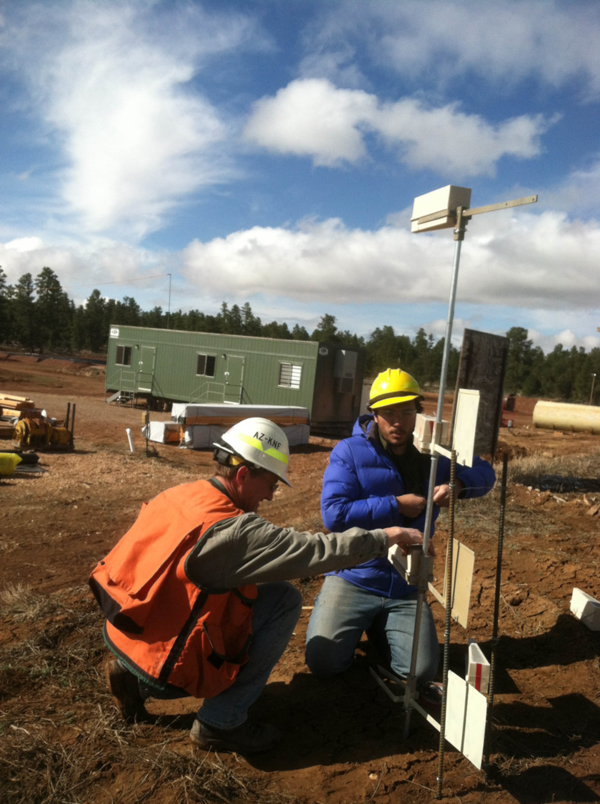 USGS and USFS scientists installing dust collectors