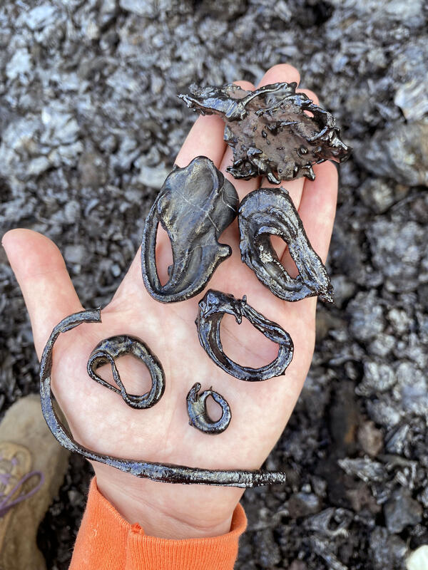Color photograph of a person's hand with volcanic glass features