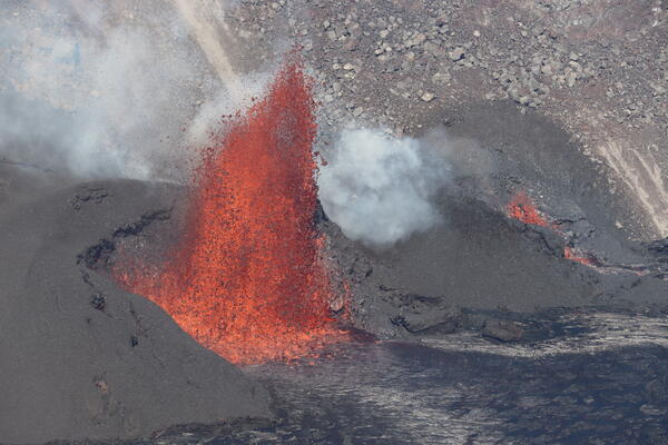 Color photograph of vent erupting lava