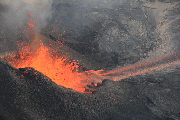 Color photograph of vent erupting lava