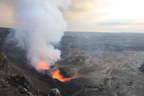 Color photograph of two volcanic vents erupting