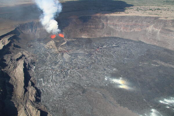Color photograph of eruption within crater