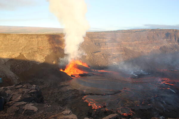 Color photograph of volcanic vents erupting lava flows