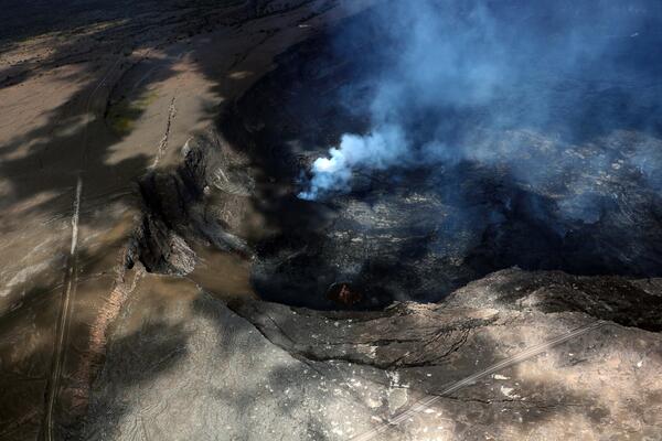 Color photograph of vents degassing in crater