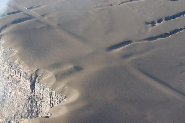 Color photograph of tephra blanket on road