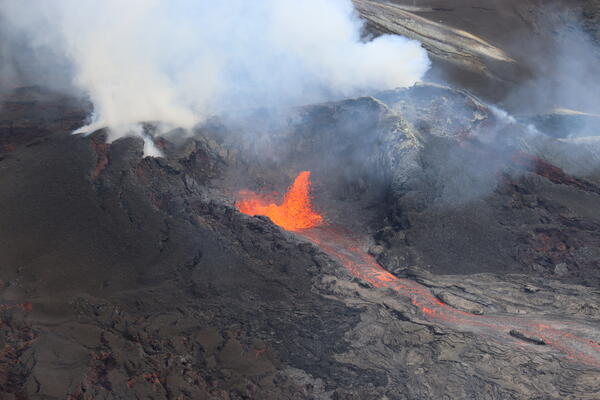 Color photograph of lava erupting from vent