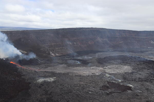 Color photograph of volcanic vents erupting within crater