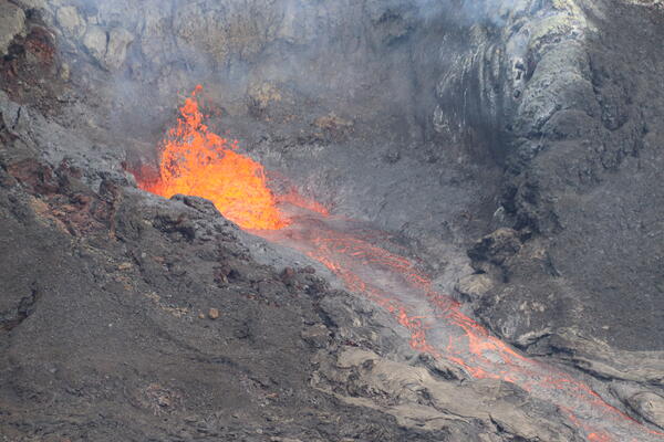 Color photograph of volcanic vent erupting