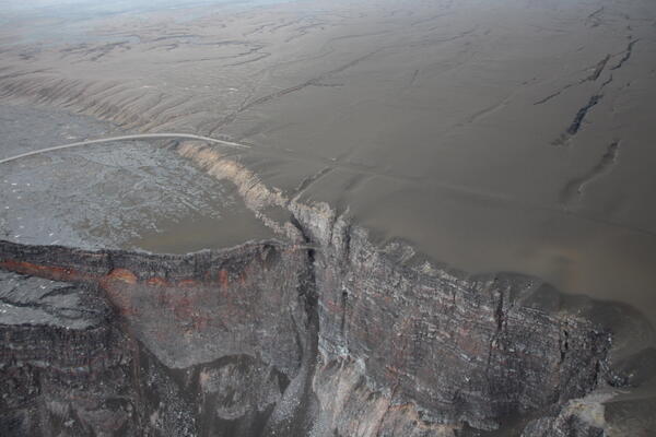 Color photograph of deposit of ejecta material from a volcanic eruption on the rim of a caldera