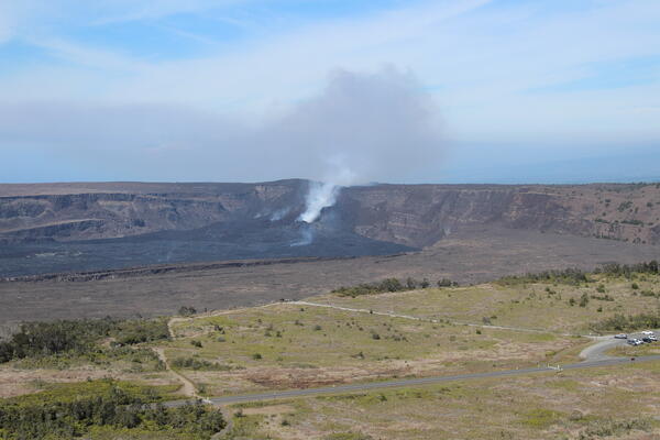 Color photograph of caldera with degassing vent within