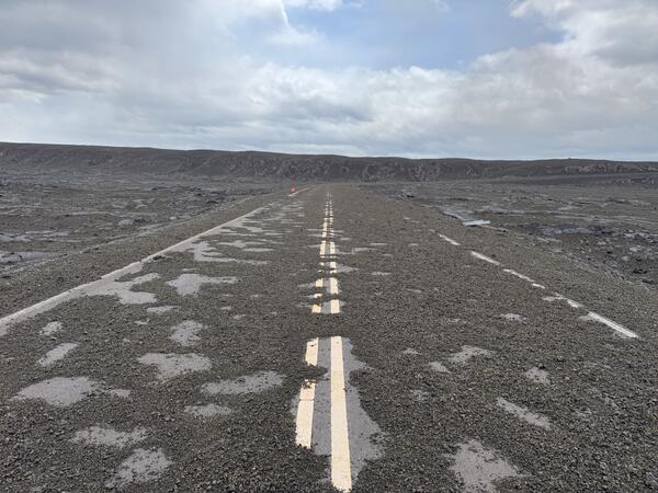 Color photograph of road covered with tephra