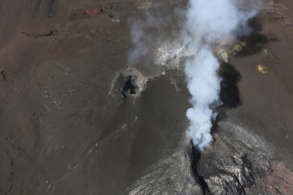 color photo looking down at what look like two small holes in the rock that are the north and south vents.