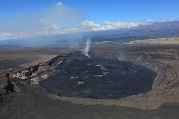 color photo of the Kaluapele with the steaming vents in the distance. 