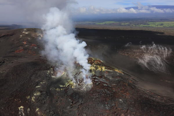Color photograph of degassing vents with sulphur deposits nearby