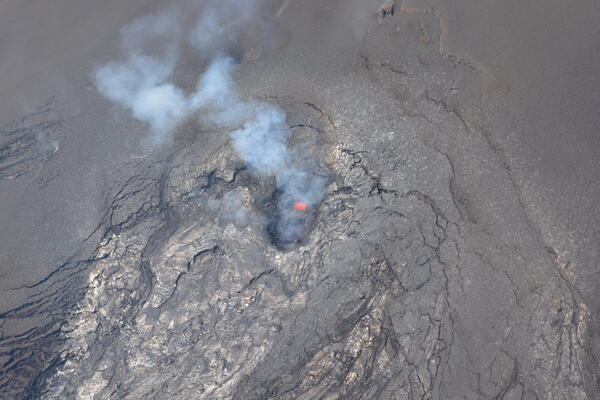 Color photograph looking down into an active volcanic vent