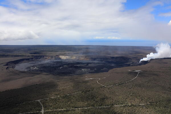 Color photograph of volcanic caldera with degassing vent