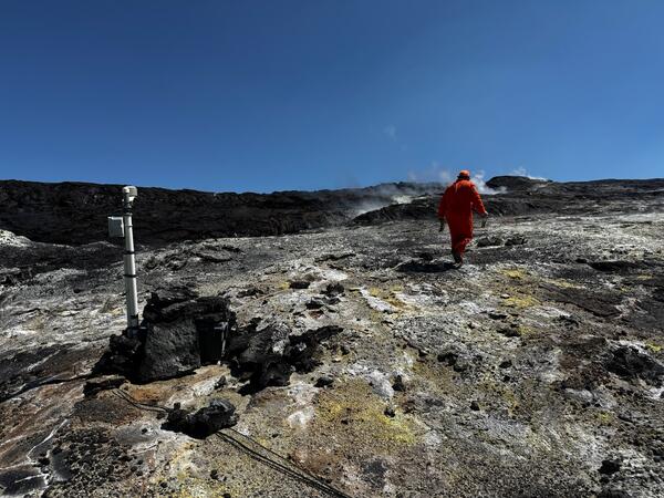 Color photograph of volcanic degassing area with monitoring instrumentation