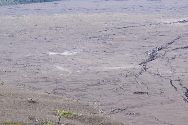 Color photograph of steaming ground cracks
