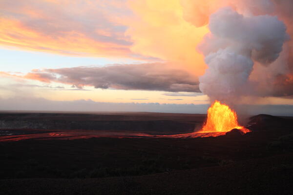 Color photograph of lava fountaining during sunrise