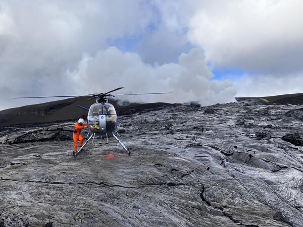Helicopter landed on black lava flows for scientists to collect samples