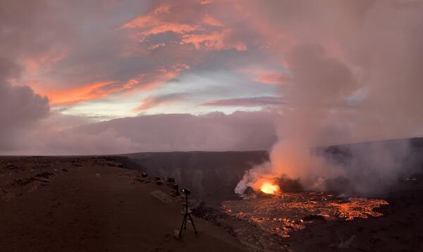 Color photograph showing eruption at sunset
