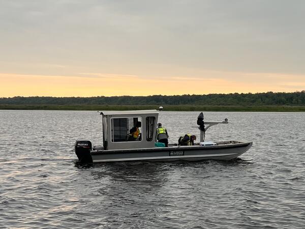 USGS research boat on river at dawn