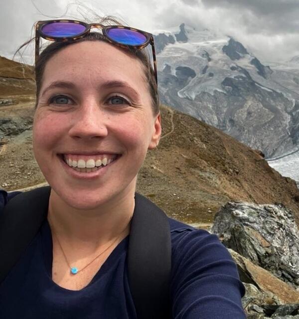 Emily Schmeltzer is a biologist wearing sunglasses on her head and blue shirt