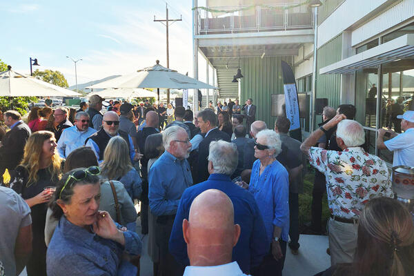 After the ceremony, attendees gather outside the new Tech Park facility to celebrate its grand opening. 