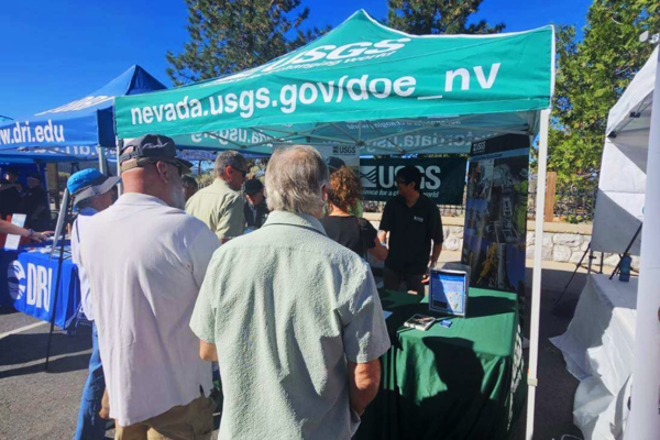 Attendees gather at the USGS booth at the 2026 Tahoe Summit