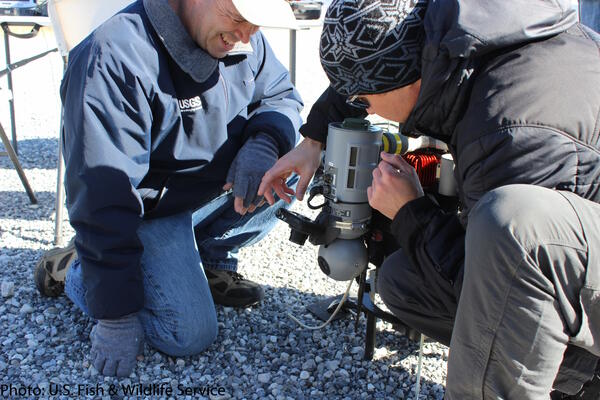 USGS scientists mounting an external sensor to a UAS