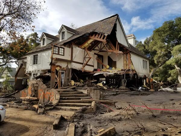 Home damaged by post fire debris flow