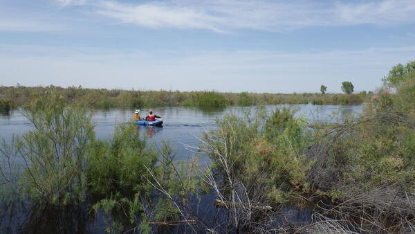 USGS scientists measure streamflow and collect sediment samples on the Colorado River. 