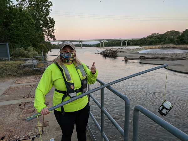 USGS scientist Chantelle Davis prepares to collect a red-dye sample