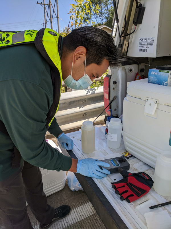 USGS scientist gets a field fluorometer reading from a recently collected red-dye study sample from the Kansas River in DeSoto.