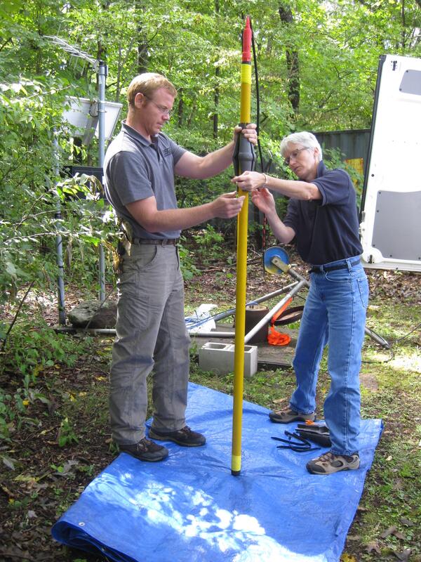 USGS scientists J. Alton Anderson and Carole D. Johnson prepare to collect a Nuclear Magnetic Resonance (NMR) log at a well. 