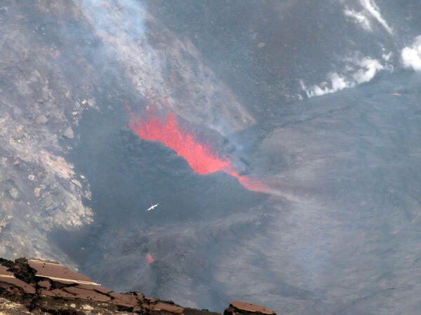 Color photograph of volcanic vent and bird