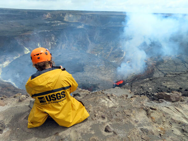 Color photograph of scientist monitoring eruption