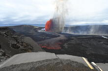 Bright lava fountain at Kīlauea viewed across the summit caldera